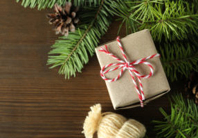 Christmas concept with gift on wooden background.