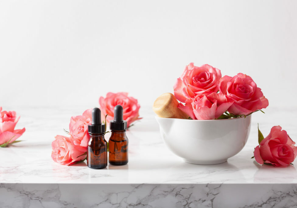 essential oils in bottles rose flowers. alternative medicine aromatherapy
